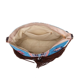 Interior detail of boho woven tote bag showing lining, zipper pocket, and fringe