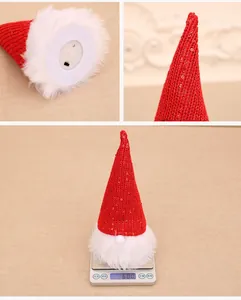 Detail showing the base of a sequin Christmas gnome with LED light switch and battery slot
