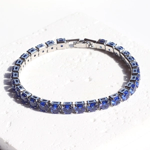 Macro view of sapphire blue tennis bracelet with silver plating and round-cut crystals