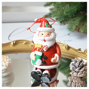 Detail of 3D Santa Claus hanging ornament on a gold mirror tray with pine needles