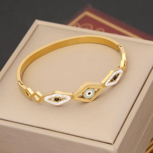 Bracciale rigido dorato in acciaio inossidabile con tre motivi romboidali malocchio