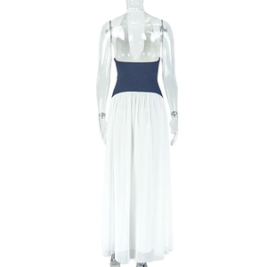 Detail of the backless deep V-neck halter dress featuring navy and white contrast panels