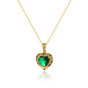 Macro detail of heart pendant with green stone and multi-colored zircon border