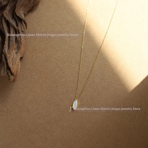 Detail of vintage marquise white shell pendant on 18K gold plated titanium chain
