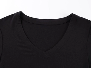 Detailed close-up of V-neckline on a black slim-fit cotton T-shirt with precise stitching