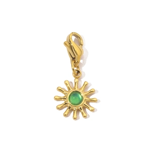 Close-up of golden sun pendant with green stone and clasp for stainless steel necklace
