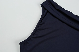 Detail of navy blue satin dress showing elegant pleated shoulder and smooth fabric texture
