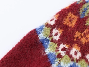 Detailed close-up of vibrant jacquard knit fabric with soft brushed wool texture
