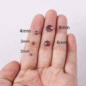 Size comparison of purple faceted crystal beads in 2mm to 8mm on a hand palm