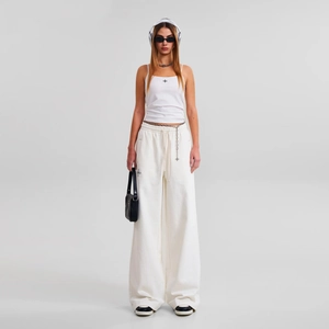Minimalist white crop top and beige wide-leg drawstring sweatpants with cross logo