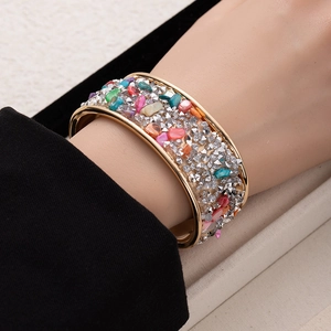 Golden wide open cuff bracelet with colorful crushed stones and sparkling diamonds