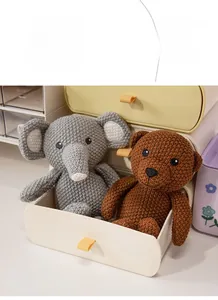 Handcrafted crochet gray elephant and brown bear plush dolls in a storage drawer