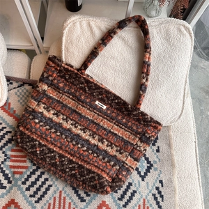 Detailed close-up of retro geometric plush fabric on the large bohemian tote bag