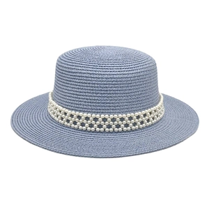 Close-up of light blue straw boater hat featuring a decorative white pearl mesh band