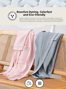 Detail of pink and grey waffle knit bathrobes with breathable fabric on a wooden chair