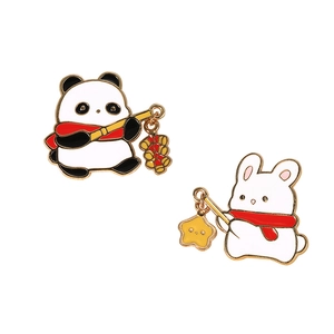 Cartoon enamel pins featuring a cute panda and rabbit with festive scarves and red crackers
