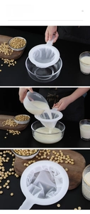 Close-up of fine mesh handheld strainer filtering fresh soy milk into a glass cup