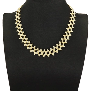 Men's gold iced-out Cuban link chain necklace with rhombic thorns on a display