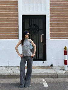 Outdoor shot of grey knit halter top and matching high-waist wide-leg trousers ensemble