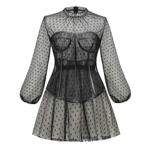 Detail of black lace long sleeve dress featuring polka dot mesh and corset waist design
