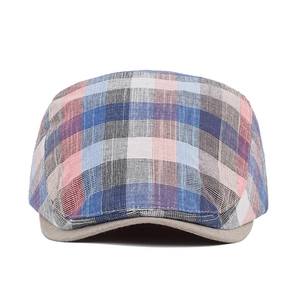Close-up of multicolor plaid flat cap showing breathable cotton linen texture and visor