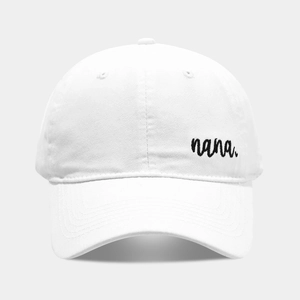 Close-up of white cotton baseball cap featuring black nana embroidered text detail