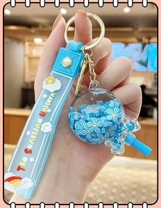 Blue unicorn keychain with silicone strap and floral sequin globe charm detail