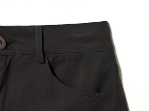 Detailaufnahme des dunklen Twill-Midirock-Bunds mit Knöpfen und feinen Nähten