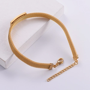Titanium steel woven mesh bracelet in gold with adjustable lobster clasp on stone