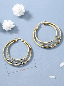 Detail view of 3.5cm double hoop earrings in gold finish with small metal beads