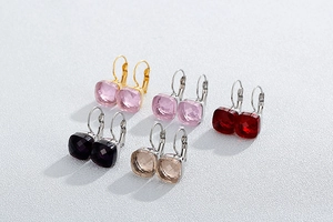 Close-up of square crystal drop earrings in five vibrant colors with steel hooks