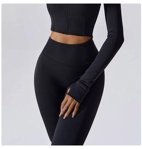 Detail of high waist yoga leggings and thumb hole cuffs on black athletic set