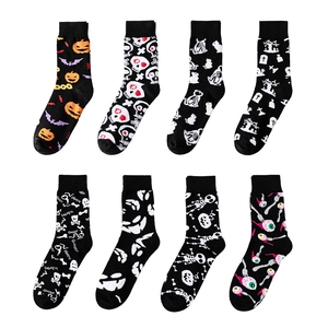 Set of eight Halloween crew socks featuring pumpkins, ghosts, and skulls on black fabric