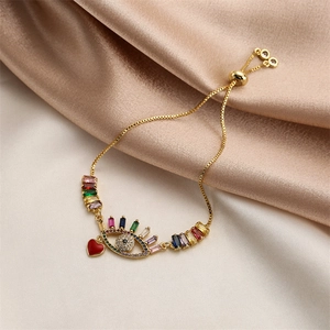 Adjustable gold evil eye bracelet with colorful cubic zirconia and heart charm