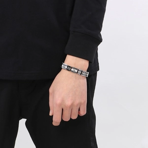 Detail of men's stainless steel bracelet featuring black silver links and square zircon