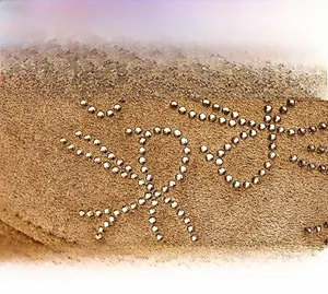 Detail shot of winter baseball cap showing rhinestone bow and premium suede texture