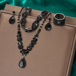 Macro shot of tiered black waterdrop pendant necklace with matching earrings and bracelet