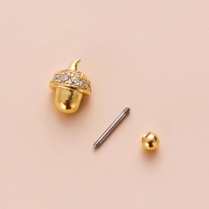 Detailed components of gold acorn piercing stud with crystal inlay and screw back