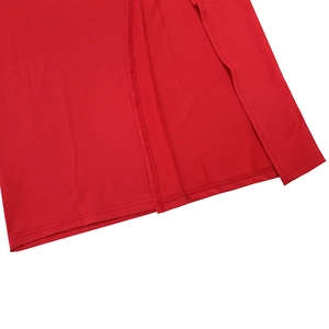 Detailed close-up of the red dress side slit hem with professional double stitching