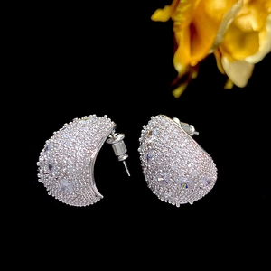 Detailed close-up of a silver semi-hoop earring featuring pavé-set round cubic zirconia