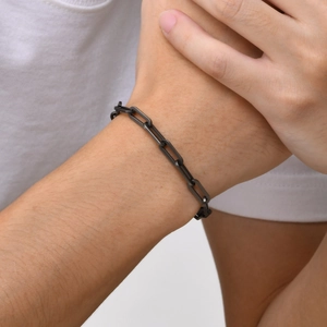Close-up of black matte geometric square link chain bracelet in punk industrial style
