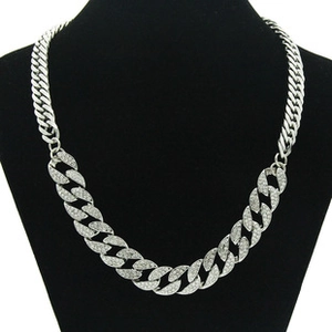 Detailed view of silver Cuban link necklace with sparkling rhinestones on black mannequin