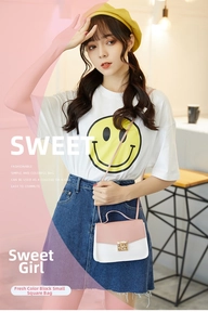 Detail of pink and white contrast square bag with golden twist lock and thin shoulder strap