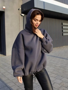 Detail of oversized dark grey hoodie featuring high-quality cotton fabric and rib cuffs