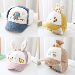 Detail view of four velvet earflap hats featuring colorful cartoon animal designs for kids