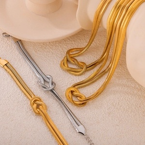 Punk style gold and silver layered snake bone jewelry set with knot design for women