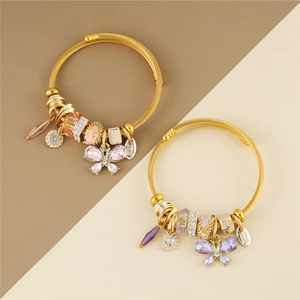 Close-up of butterfly crystal charms and hand-made tags on woven steel wire bracelets