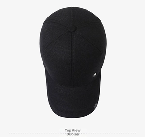 Detail of black winter baseball cap with side sport label and metal logo decoration