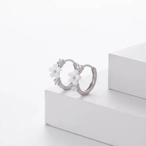 Close-up of S925 sterling silver hoop earrings with white flowers and zircon stones