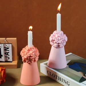 Detailed view of floral relief pattern on coral pink silicone candle holder mold